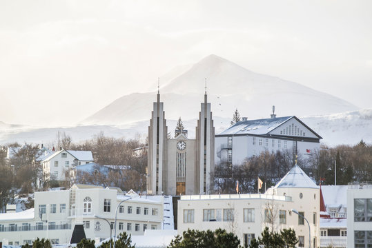 view of nordic church with mountains in Akureyri Iceland