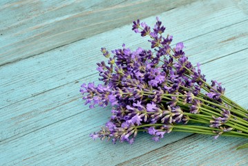 Bouquet of lavender on an old blue wooden background in the style of Provence close up
