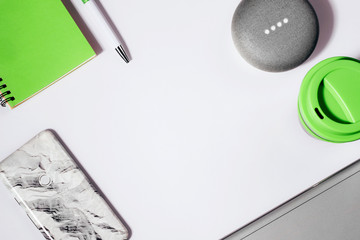 Digital Assistant concept. Flat lay of smart speaker with LED lights activated with cropped...