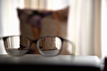 Glasses ,pillow on the table 