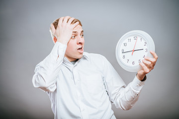 Businessman holding large clock