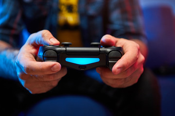 Gamer holding Gamepad, Controller or Videogame Joystick Console in hands. Close up, game concept