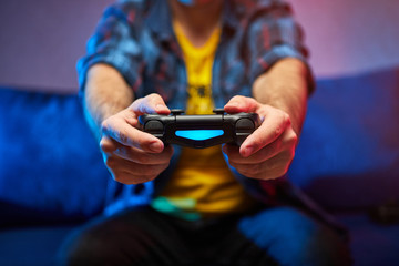 Gamer holding Gamepad, Controller or Videogame Joystick Console in hands. Close up, game concept