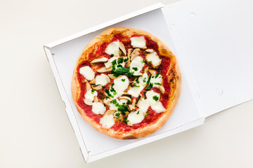 pizza with mushrooms in a box for delivery, advertising or menu