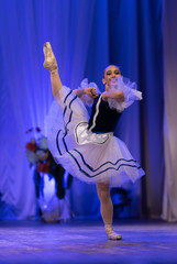 Young girls ballerina in a blue and white costume dancing ballet performance on stage in a theater © Kozlik_mozlik