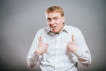 Handsome happy man pointing himself isolated