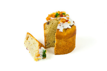 Easter cake with candied fruit with a cut piece on a white background