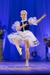 Young girls ballerina in a blue and white costume dancing ballet performance on stage in a theater © Kozlik_mozlik