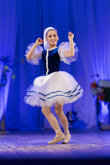 Young girls ballerina in a blue and white costume dancing ballet performance on stage in a theater © Kozlik_mozlik