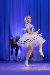 Young girls ballerina in a blue and white costume dancing ballet performance on stage in a theater © Kozlik_mozlik