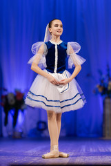 Young girls ballerina in a blue and white costume dancing performance on stage in a theater © Kozlik_mozlik