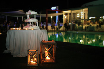 Wedding cake with candles and roses