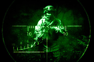 Portrait of a commando in the night sight of a sniper rifle. The concept of military operations,...