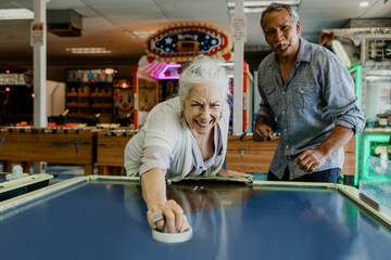 Senior couple playing table hockey