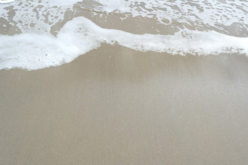 Sea wave over sand