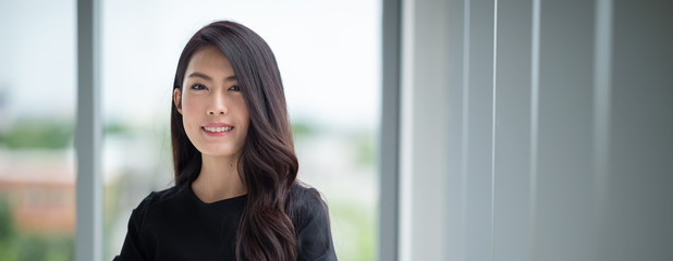 Headshot young lady standing in office