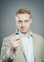 Cheerful corporate man holding key