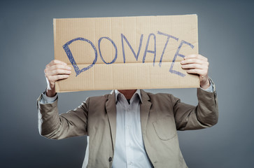 man holding Cardboard text a donate