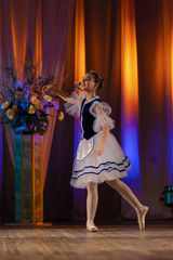 Young girls ballerina in a blue and white costume dancing performance on stage in a theater © Kozlik_mozlik