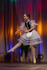 Young girls ballerina in a blue and white costume dancing performance on stage in a theater © Kozlik_mozlik