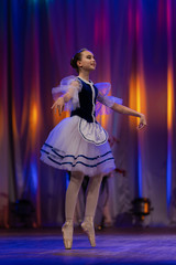 Young girls ballerina in a blue and white costume dancing performance on stage in a theater © Kozlik_mozlik