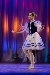 Young girls ballerina in a blue and white costume dancing performance on stage in a theater © Kozlik_mozlik