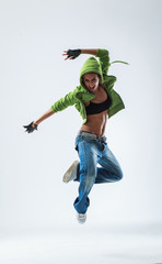 young woman jumping on studio backdrop