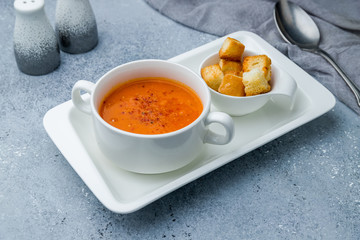 Soup cream of tomato on grey table