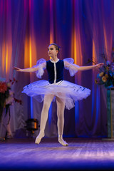 Young girls ballerina in a blue and white costume dancing performance on stage in a theater © Kozlik_mozlik
