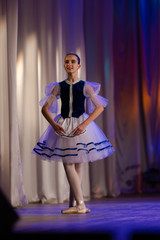 Young girls ballerina in a blue and white costume dancing performance on stage in a theater © Kozlik_mozlik