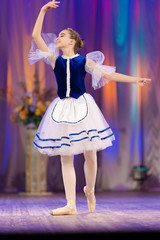 Young girls ballerina in a blue and white costume dancing performance on stage in a theater © Kozlik_mozlik