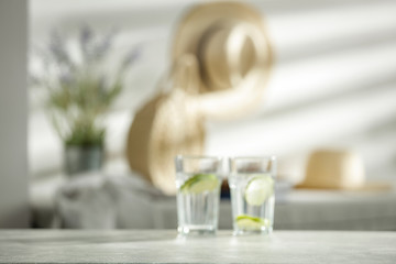 Mineral water on a wooden table in the morning sunlight with free space for an advertising product