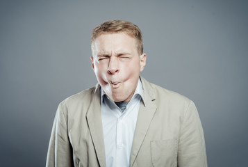 Man making funny face and grimacing