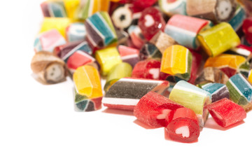 mix of multi-colored bright sweet lollipops isolated on a white background. close up. macro