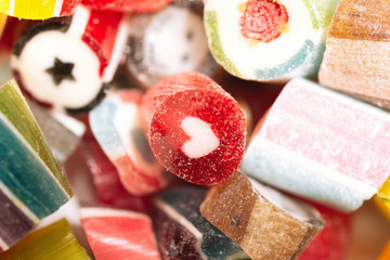 mix of multi-colored bright sweet lollipops isolated on a white background. close up. macro