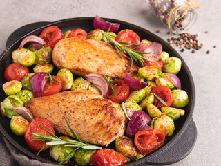 roasted chicken fillet with vegetables, brussels sprouts, onions, tomato