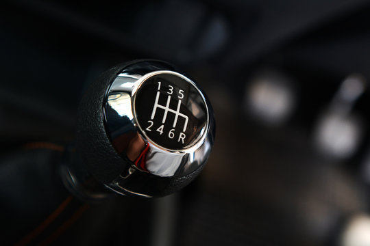 Manual six-speed gearshift for a car, Closeup photo of car interiors in dark light