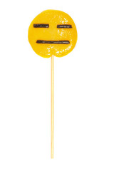 round yellow lollipop on a stick with a face of indifference isolated on a white background. Close-up