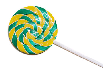 round bright yellow-green lollipop ia spiral form isolated on a white background. Close-up. Macro