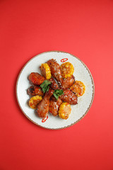 spicy chicken legs sprinkled with sweet corn sauce on a clean background