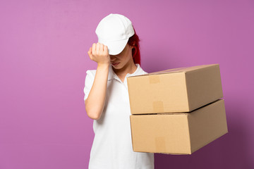 Teenager delivery girl isolated on purple background with headache