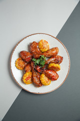 spicy chicken legs sprinkled with sweet corn sauce on a gray background