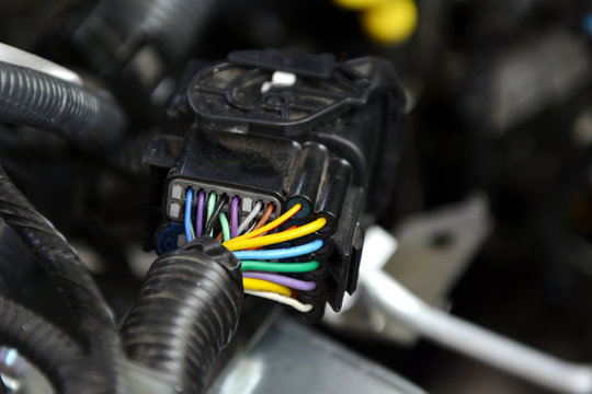 Multicolored wires plug in car, Close up automotive wiring