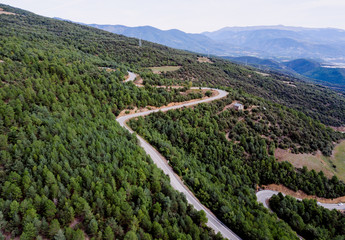 Fototapeta na wymiar Aerial view of a rural highway between mountains.