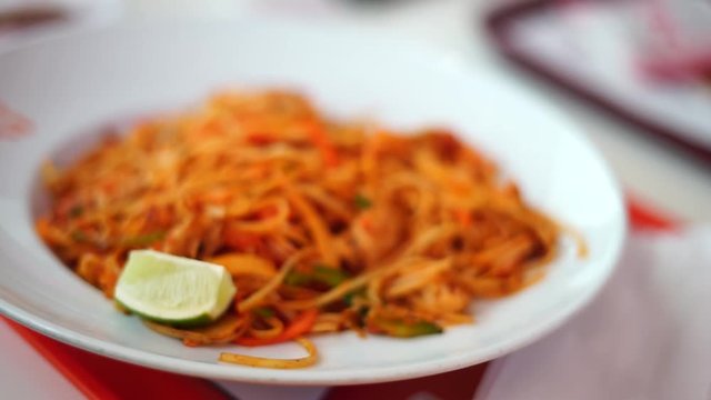 Fork taking japanese pasta from a plate