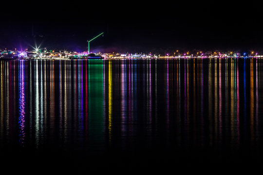 A colorful reflection of the night lights of Zrce beach in the sea