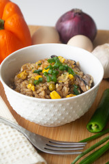 Chinese style vegetarian egg fried rice with sweet corn, green peas, onions, garlic, mushrooms and scallions