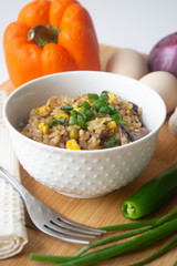 Chinese style vegetarian egg fried rice with sweet corn, green peas, onions, garlic, mushrooms and scallions