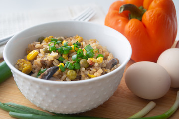 Chinese style vegetarian egg fried rice with sweet corn, green peas, onions, garlic, mushrooms and scallions