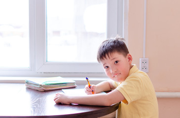 Asian child boy student in medical face mask homework online lesson at home, epidemic Coronavirus, MERS-CoV, 2019-nCoV, quarantine, Covid-19 self-isolation, online education, home schooling